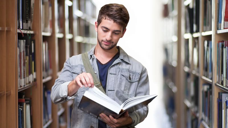 Male student studying in the library